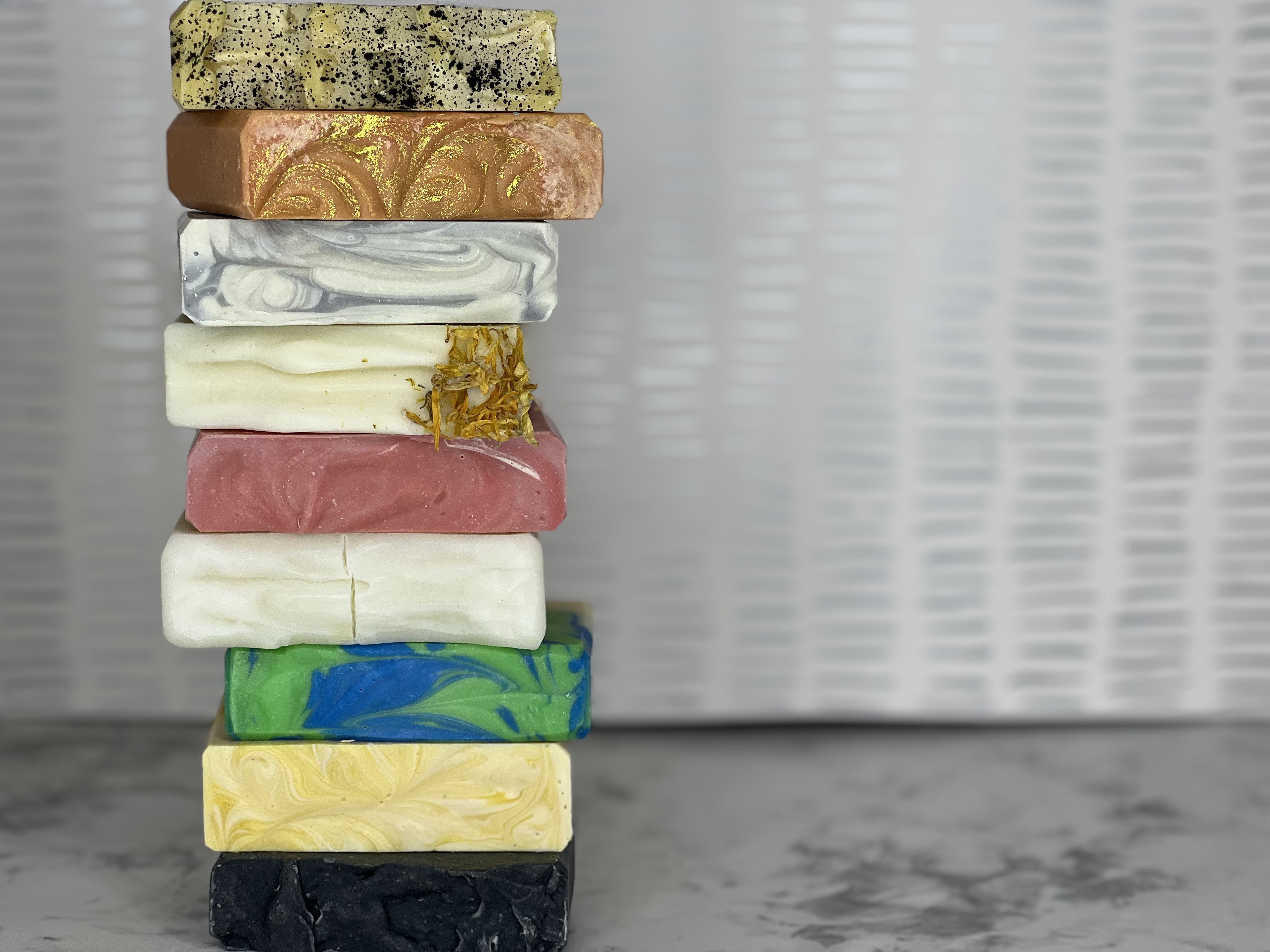 Stacked bars of handmade soap on light colored background